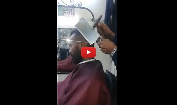 This Barber is cutting his client's hair with Meat Cleaver 