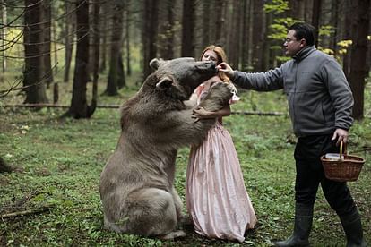 woman takes photos with wild animals
