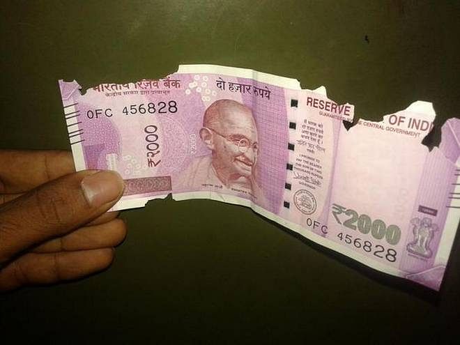 man withdraws new 2000 rupees from bank and then it crumbles into pieces 