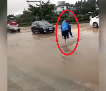 old man carrying wife on his back across puddles viral video