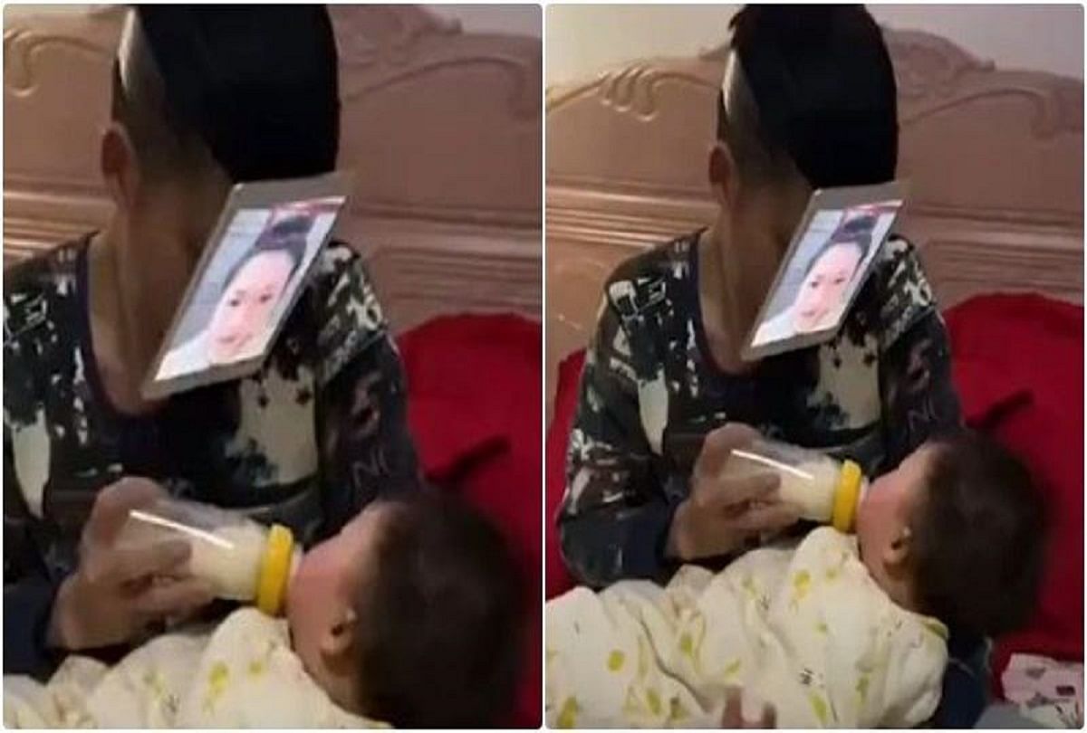 viral video of chinese man who tapes his wife photo on his face to feed his baby