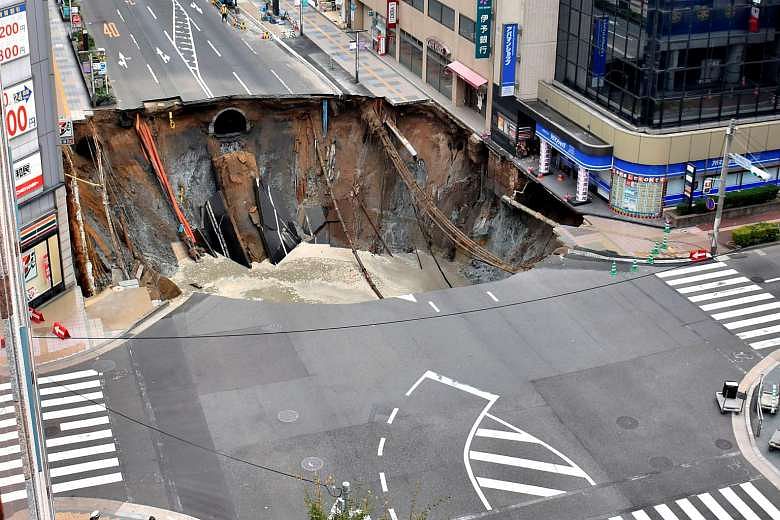 a giant sink hole swallows entire 5 lane street in japan  