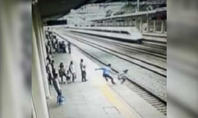 Viral and Trending Video of a man saving a girl from jumping in front of train