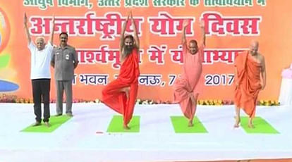 UP CM Yogi Adityanath practices yoga with Yoga Guru Baba Ramdev in Lucknow