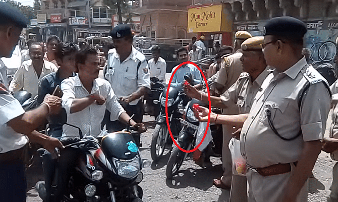 Rajsthan police force appeal to two wheeler to wear helmet by giving them roses 