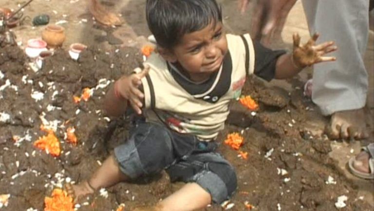 children dipped in cow dung weird ritual in madhya pradesh