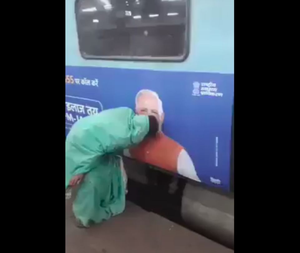 woman kissing narendra modi poster on metro station video viral