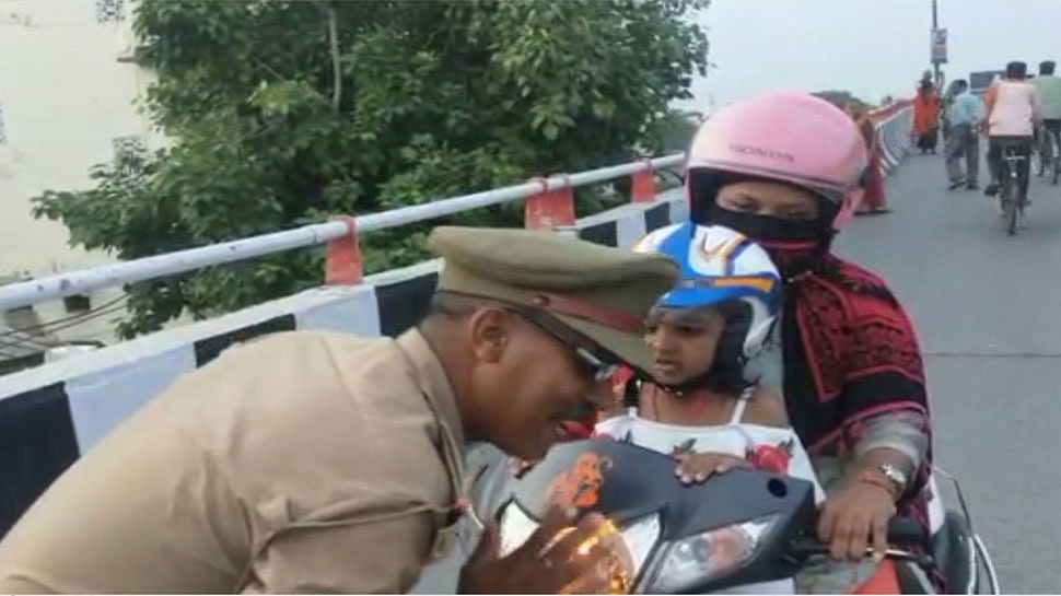 viral video of traffic police salute mother and daughter wearing helmet on scooty