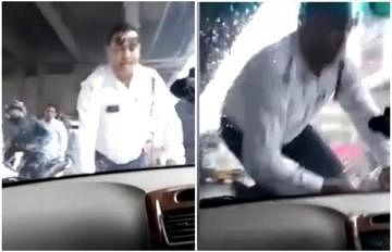 viral video of traffic police driving  man drags traffic cop on bonnet