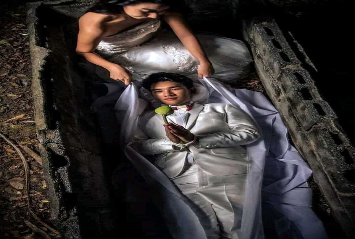 weird pre wedding photoshoot where bride and groom pose in coffins and have fake cremation