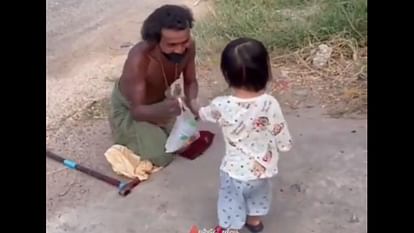A little girl gave a bottle of water to a disabled person