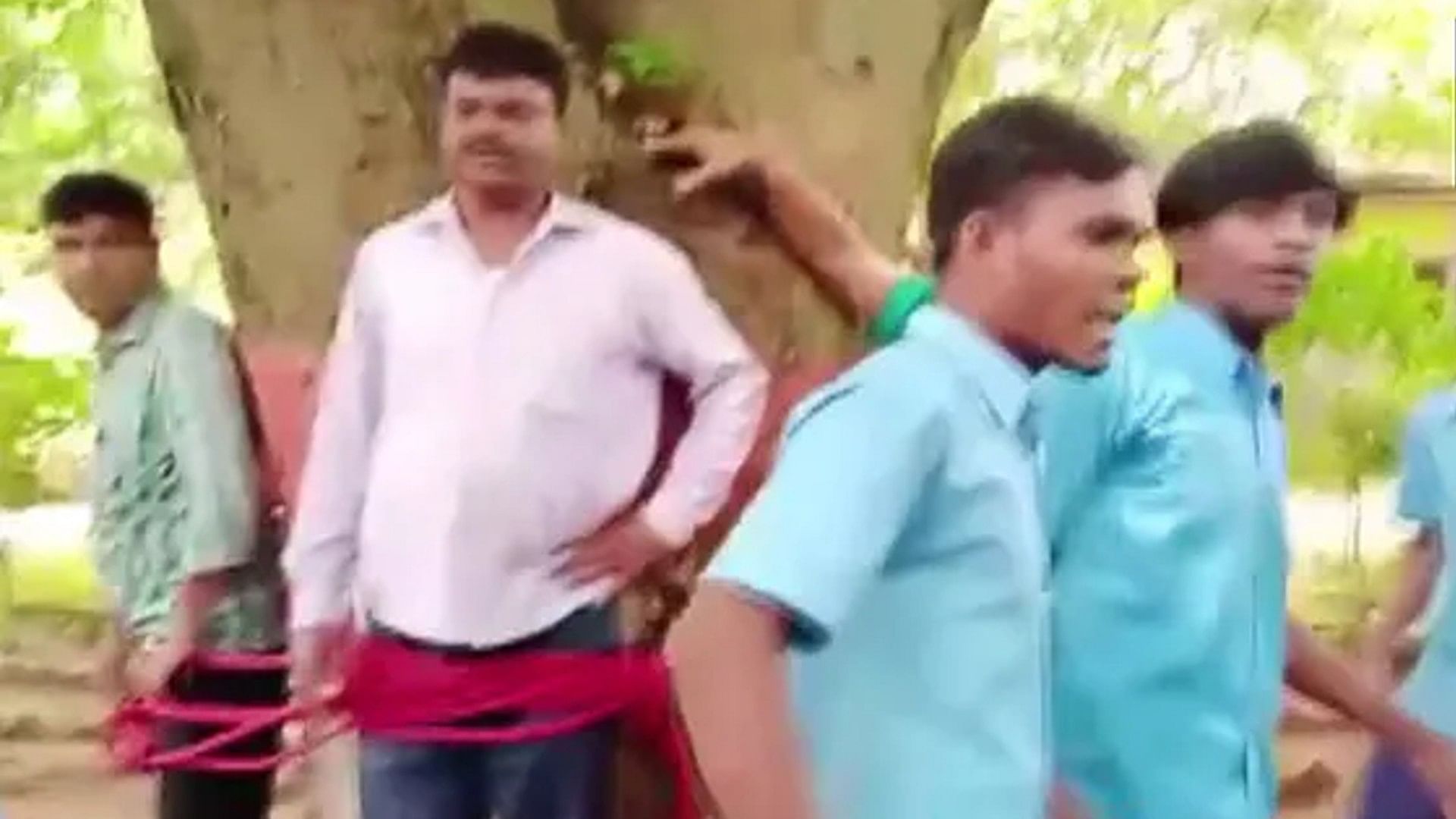 after failing in the exam Students beat teachers by tying them to a tree viral news