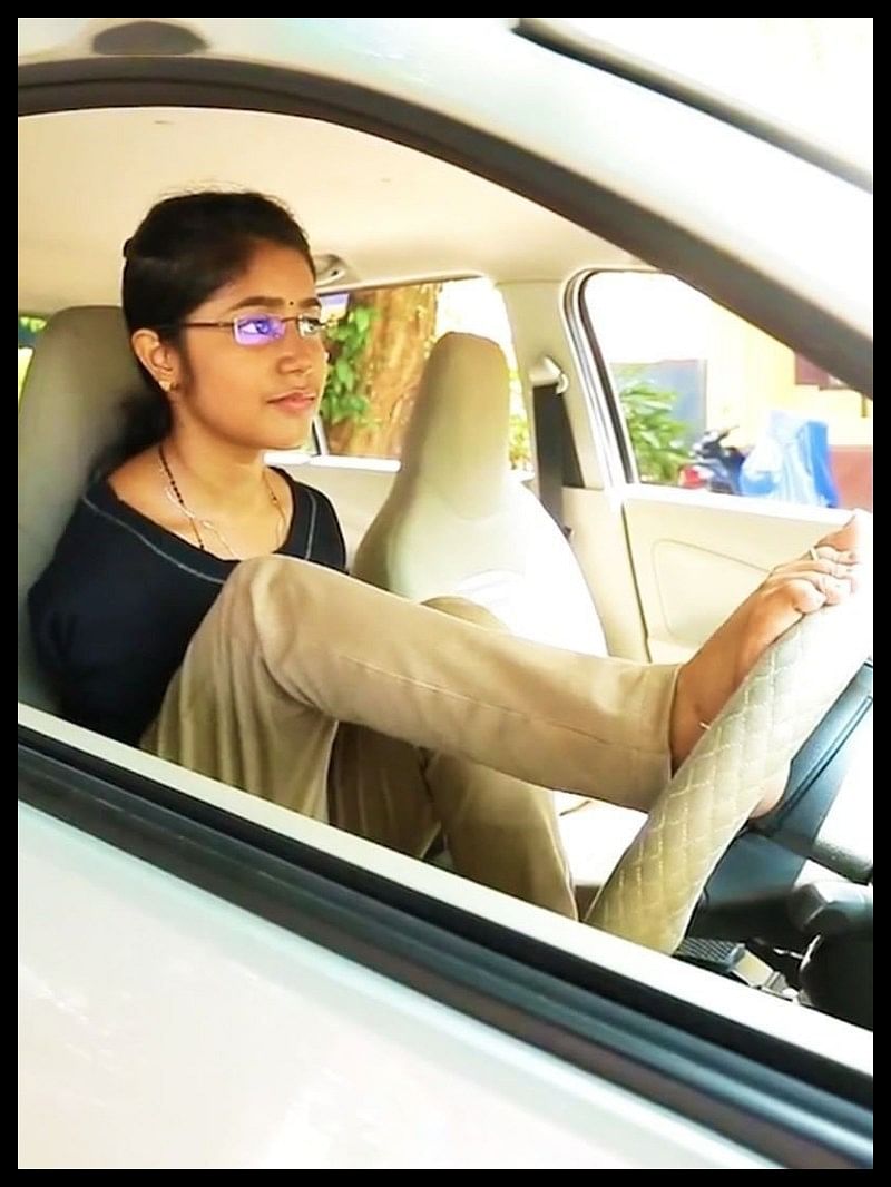 Asia first kerala woman gets driving license to drive a car without both arms drive car with feet