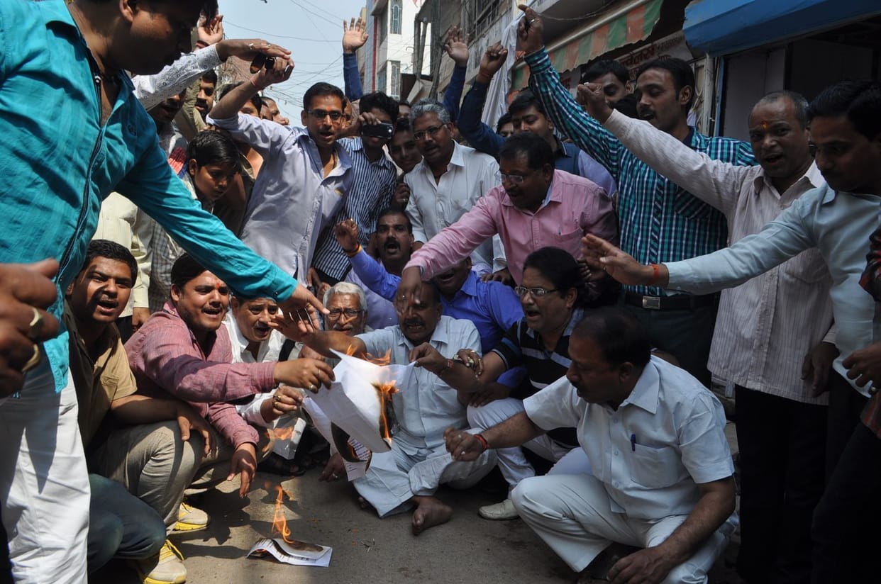 Traders burn copies protests