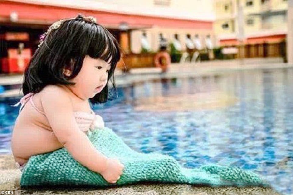 parents dressed their kid as mermaid