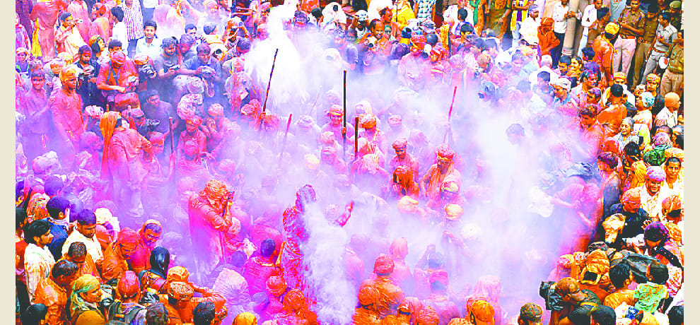 women play holi with colours and beat men with swinge
