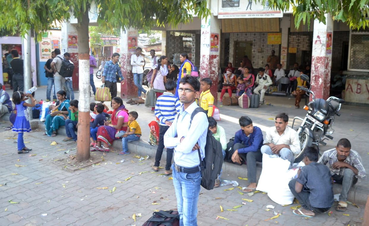 crowd of passengers at bus stop