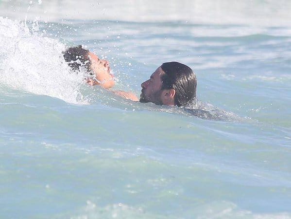 Actor Hugh Jackman helps swimmers to safety from dangerous surf