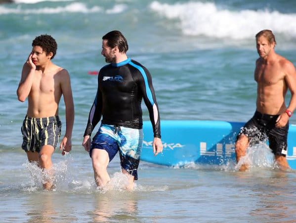 Actor Hugh Jackman helps swimmers to safety from dangerous surf