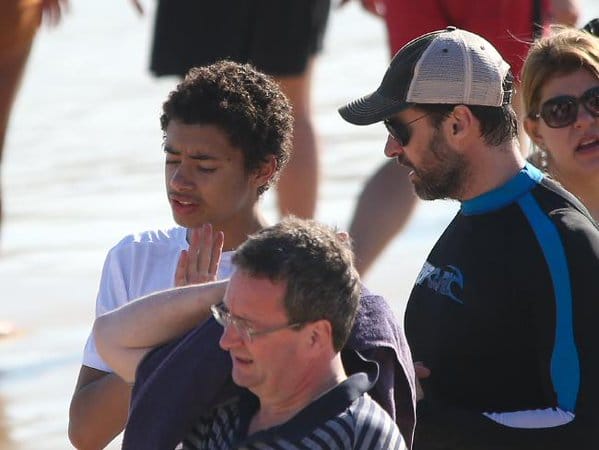 Actor Hugh Jackman helps swimmers to safety from dangerous surf