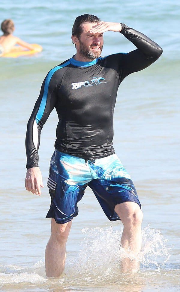 Actor Hugh Jackman helps swimmers to safety from dangerous surf