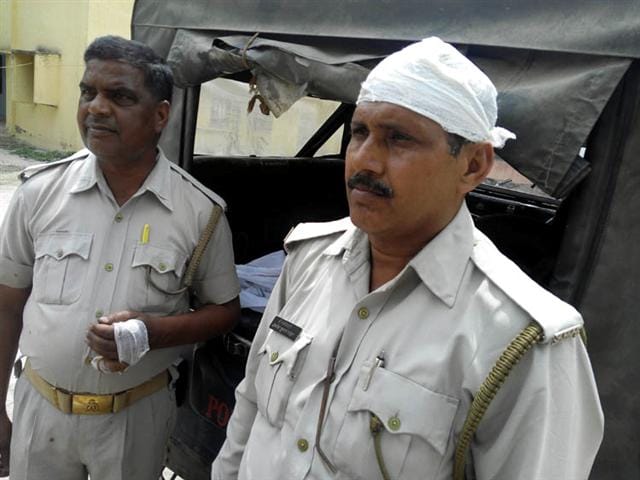 The villagers threw stones at police , injuring two soldiers