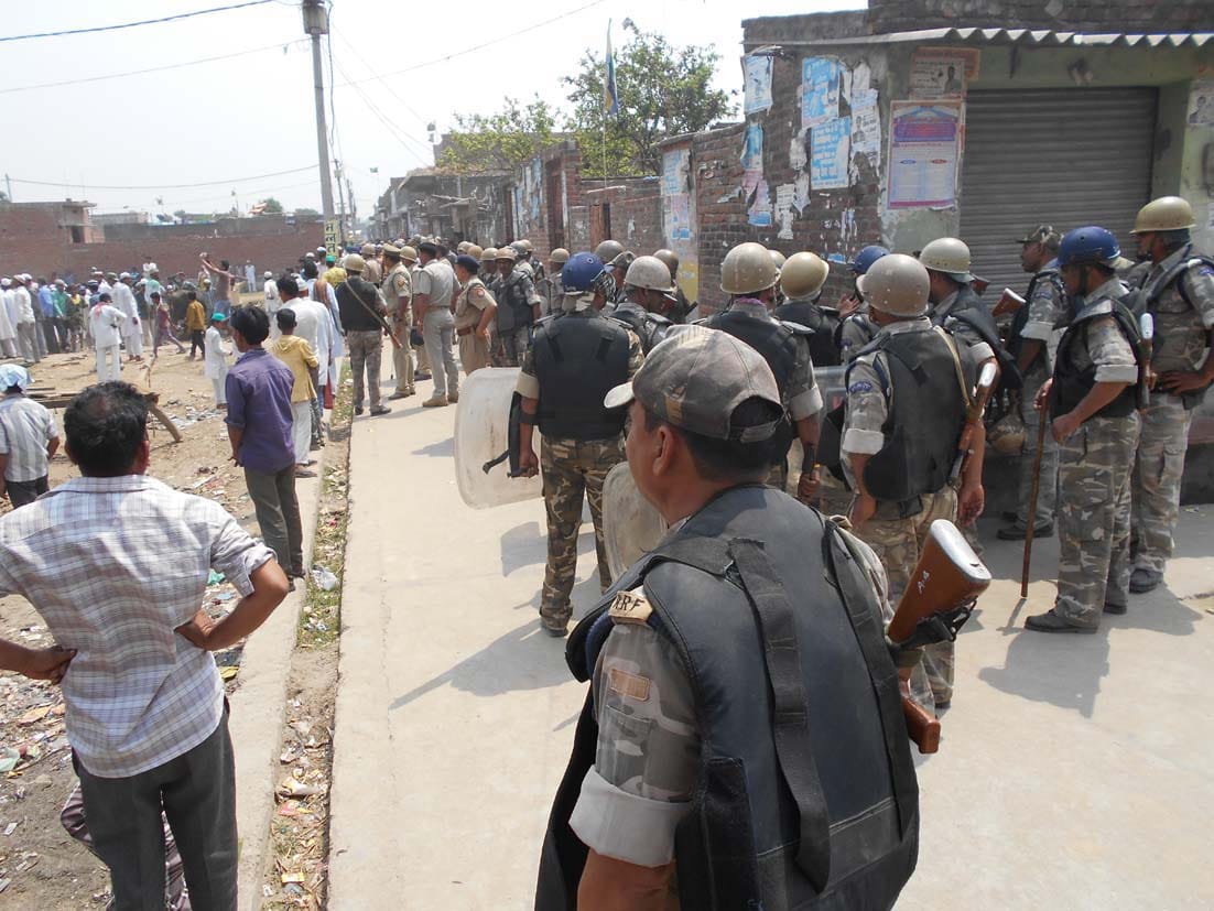The bodies of two men buried amid tight security