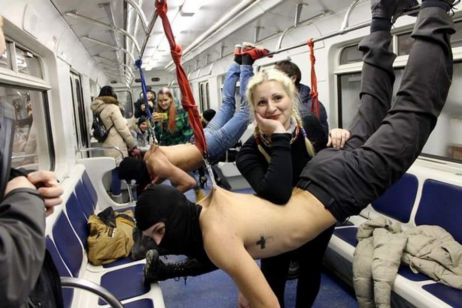 people hook themselves to metal hook and travelled in metro