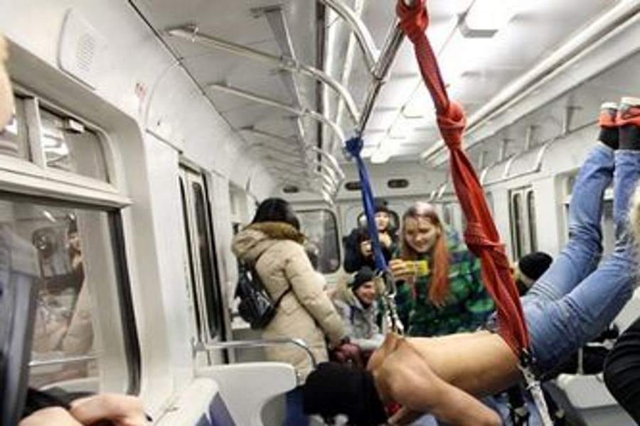 people hook themselves to metal hook and travelled in metro
