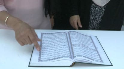 Girl helping refugees by Quran 