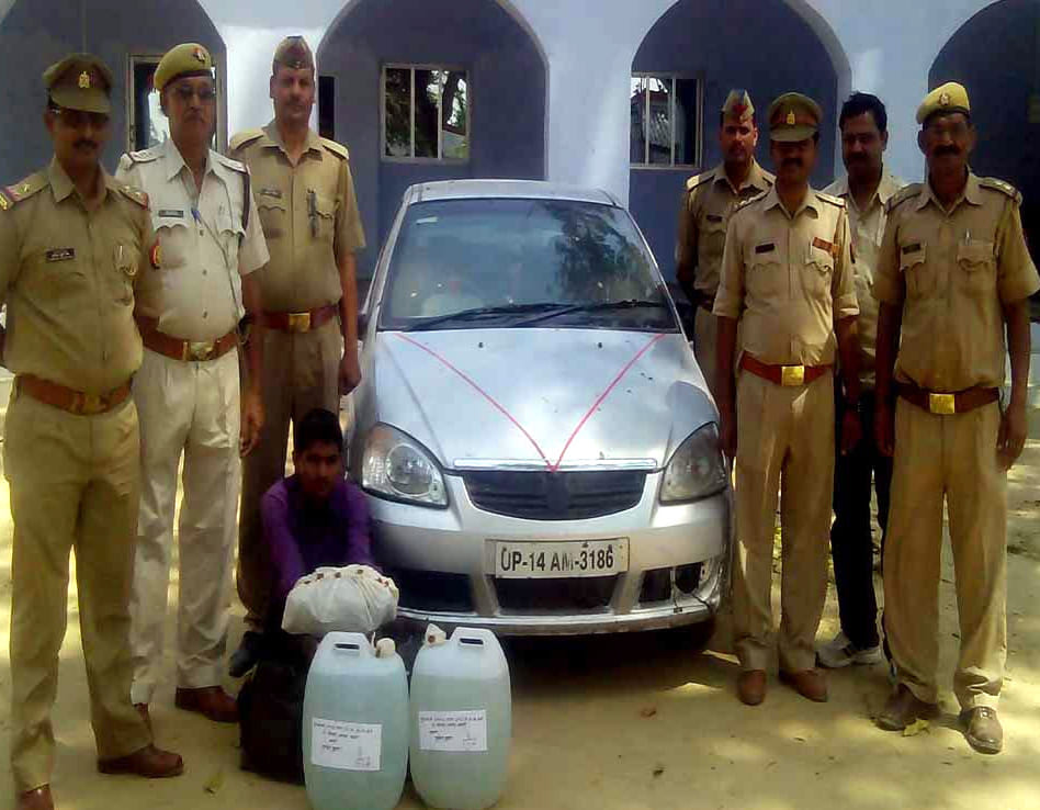 liqure recover in car, one arrested