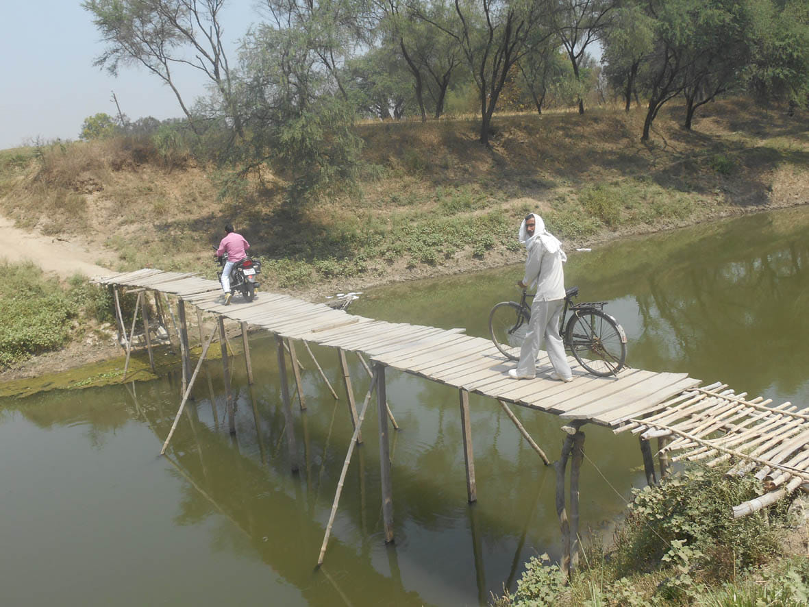 villagers convey on cart bridge