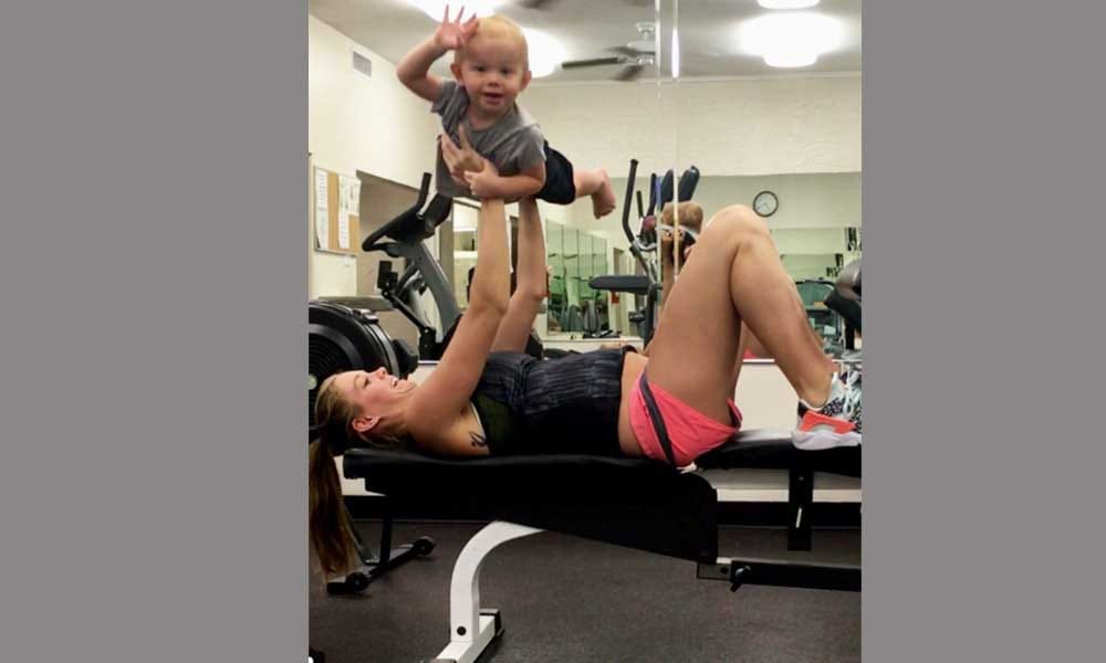pregnant Woman exercises with 19 months toddler