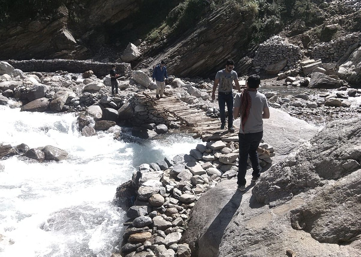 villagers crossing river by trolly