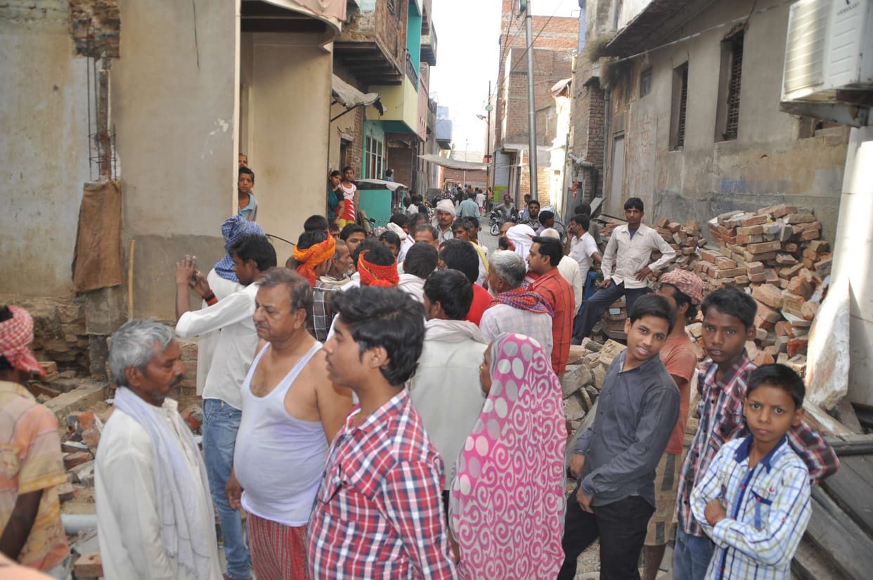 Wall fell, killing a worker, three injured