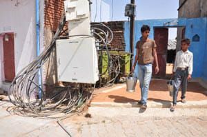Houses hit high tension line coil , current ran