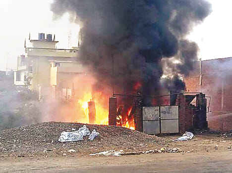 Flames rise from the tire shop fire