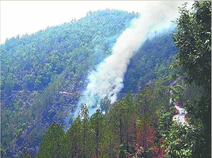 Forest fire, mist covered mountain