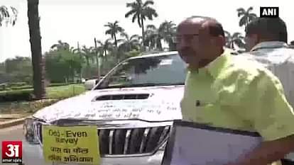 Vijay Goel drives a car pasted with news reports against Odd-Even scheme