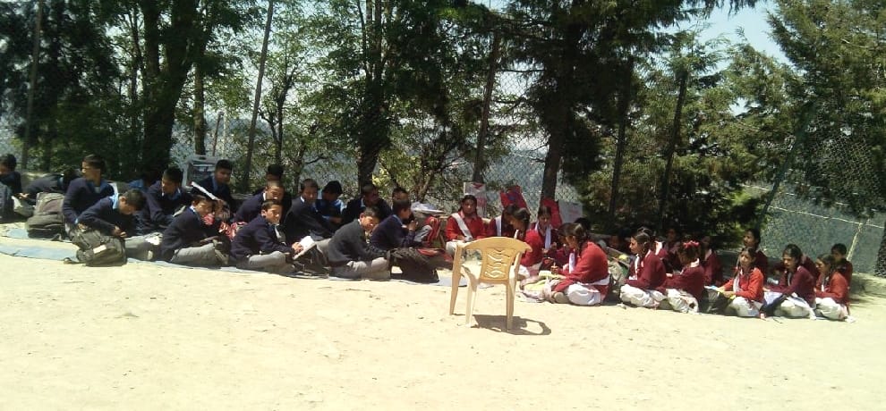 chamyana school students forced to study in open ground.