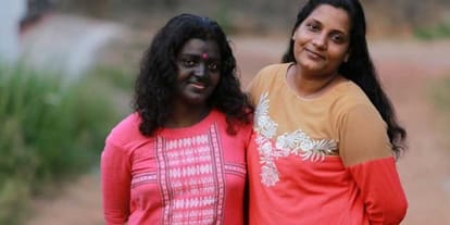 Kerela based woman applies black paint on face