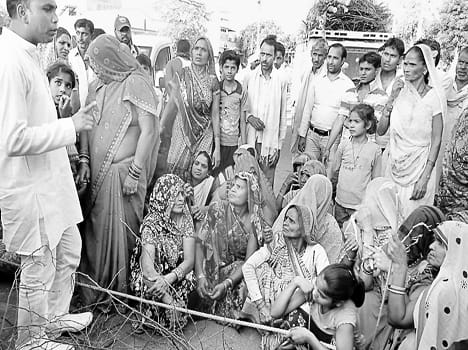 womens block the road due to water logging