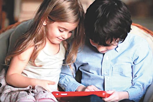 Children reading the book in the tab