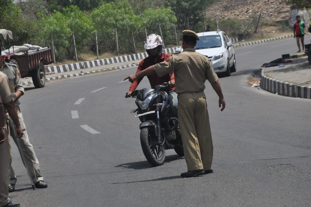 police campaign for double helmet on out side road.