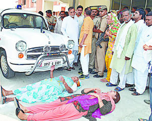 mother and her daughter lay in front of  DM's car  