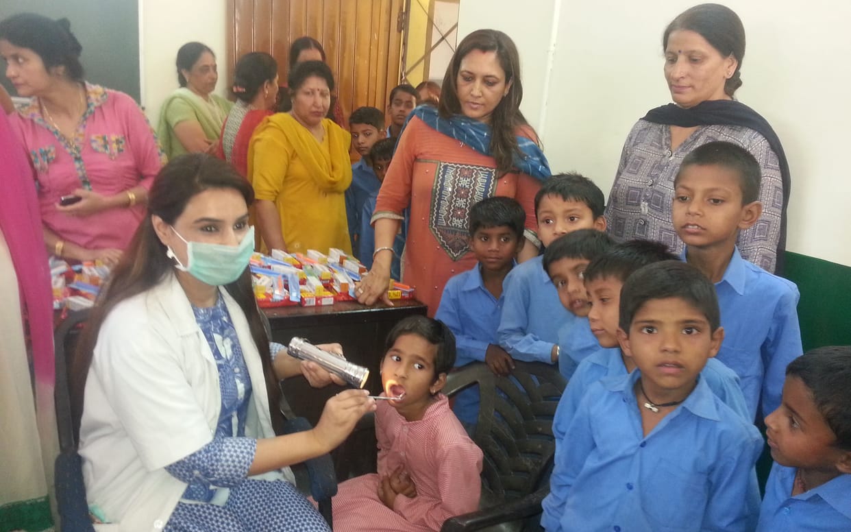 children teeth checkup in camp