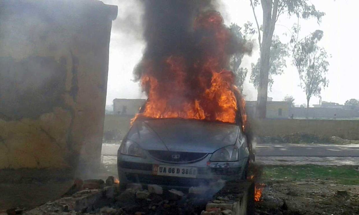 Abandoned car burned by flames