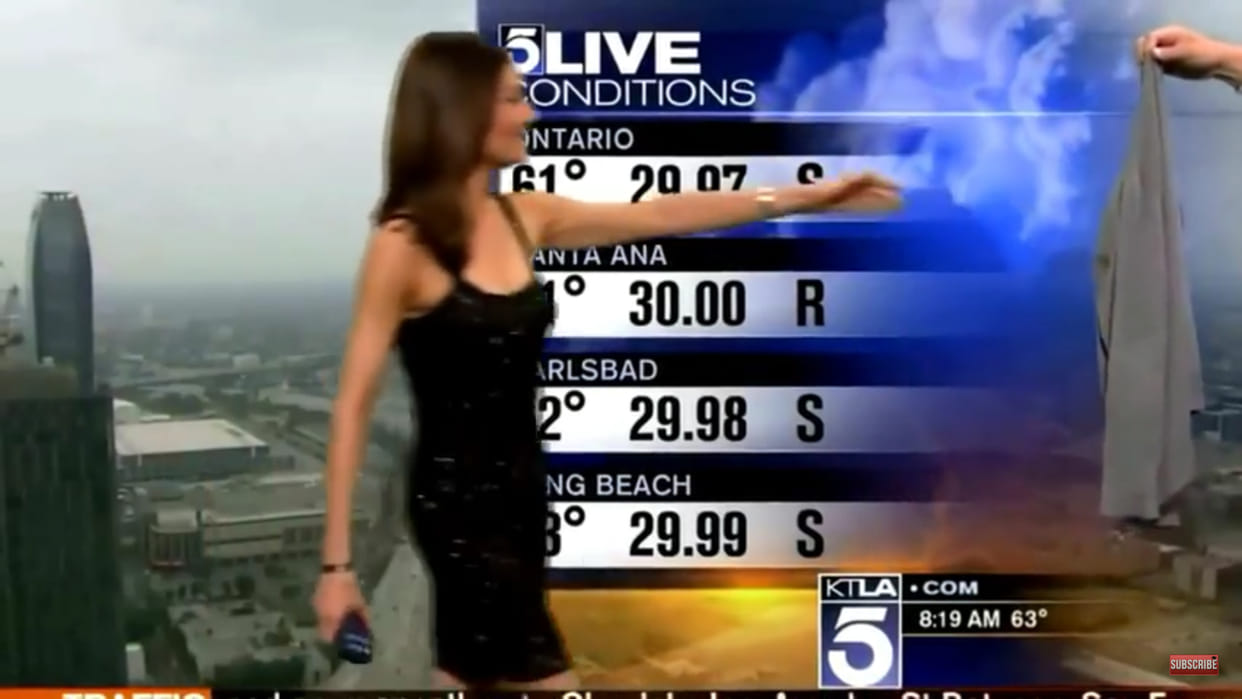 anchor handed a sweater to cover her dress
