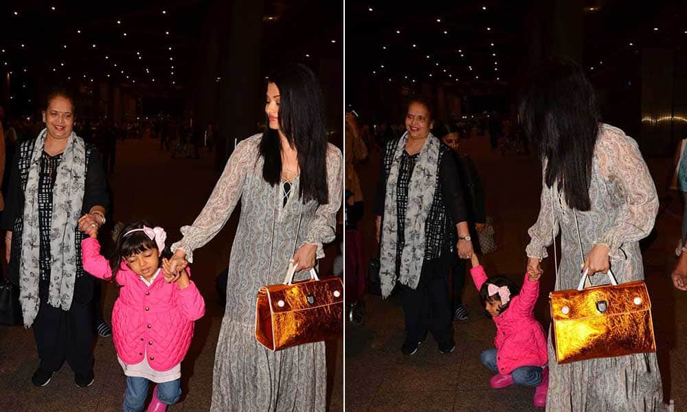 Aishwarya Rai returns from cannes with tired daughter