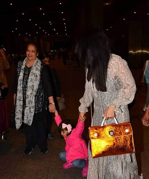 Aishwarya Rai returns from cannes with tired daughter